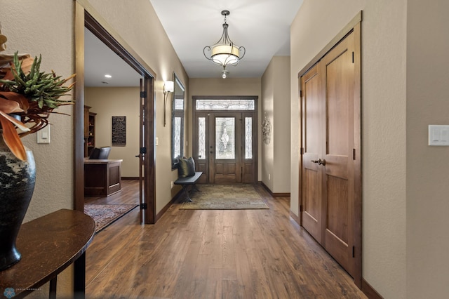 106 Beaton Dr, West Fargo, ND 58078 - foyer entrance with hardwood / wood-style flooring, a textured wall, and baseboards