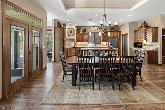 106 Beaton Dr, West Fargo, ND 58078 - dining space with dark wood-type flooring, a chandelier, a tray ceiling, and recessed lighting