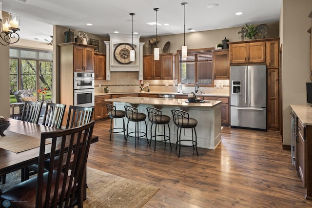 106 Beaton Dr, West Fargo, ND 58078 - kitchen with stainless steel appliances, backsplash, recessed lighting, a center island, and pendant lighting