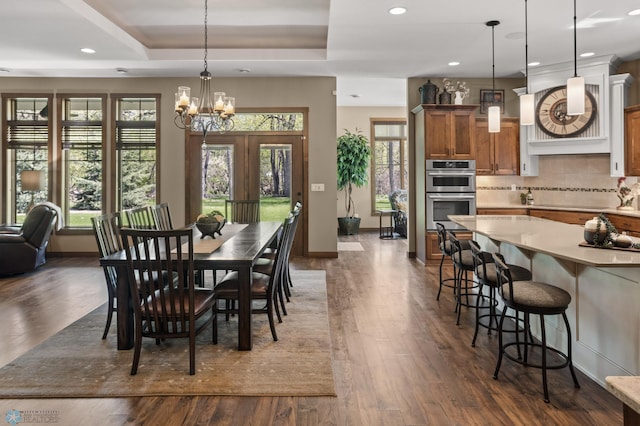 106 Beaton Dr, West Fargo, ND 58078 - dining space with a chandelier, recessed lighting, dark wood-style floors, baseboards, and a raised ceiling