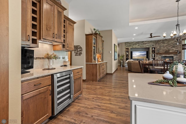 106 Beaton Dr, West Fargo, ND 58078 - kitchen with beverage cooler, open floor plan, brown cabinetry, dark wood-type flooring, and a chandelier