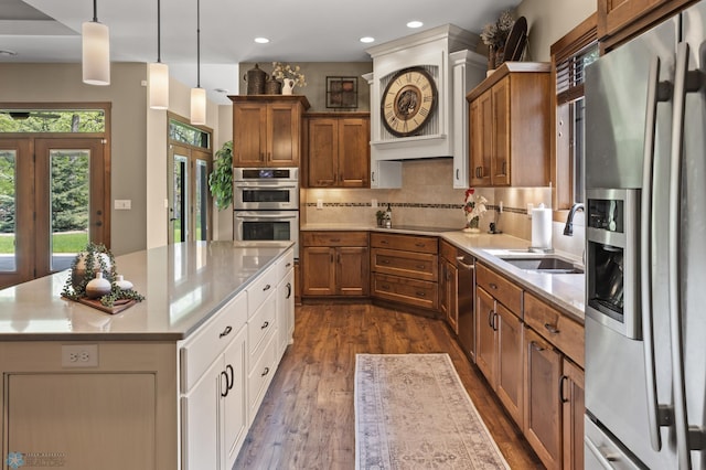 106 Beaton Dr, West Fargo, ND 58078 - kitchen featuring stainless steel appliances, a sink, brown cabinets, light countertops, and recessed lighting
