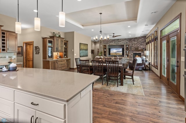 106 Beaton Dr, West Fargo, ND 58078 - kitchen featuring dark wood-type flooring, open floor plan, a chandelier, a tray ceiling, and decorative light fixtures