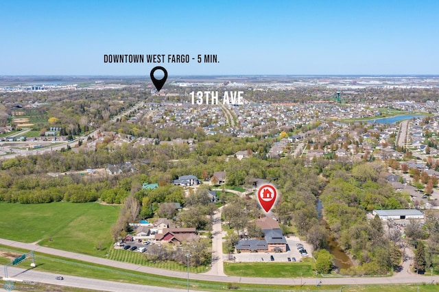 106 Beaton Dr, West Fargo, ND 58078 - aerial overview of property's location with a large body of water and a tree filled landscape