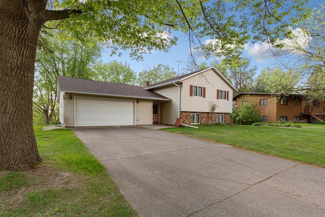 16 Crestview Bay, Faribault, MN 55021 - split level home featuring a garage, concrete driveway, a front lawn, and a chimney