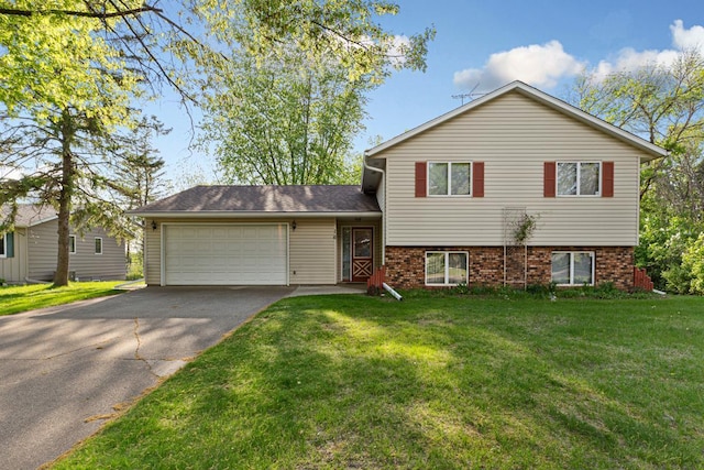 16 Crestview Bay, Faribault, MN 55021 - tri-level home featuring an attached garage, driveway, a front yard, and brick siding