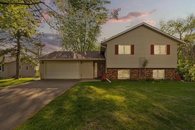 16 Crestview Bay, Faribault, MN 55021 - split level home featuring concrete driveway, an attached garage, and a front lawn