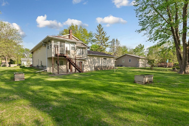 16 Crestview Bay, Faribault, MN 55021 - back of property featuring stairway, a sunroom, a chimney, a yard, and a wooden deck