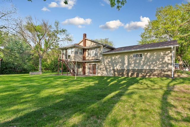 16 Crestview Bay, Faribault, MN 55021 - back of property featuring stairway, a yard, and a chimney