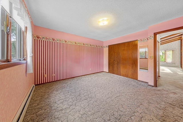 16 Crestview Bay, Faribault, MN 55021 - carpeted empty room with a baseboard radiator and a textured ceiling