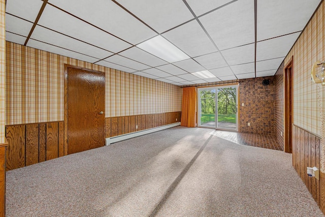 16 Crestview Bay, Faribault, MN 55021 - carpeted spare room with baseboard heating, wallpapered walls, wainscoting, a drop ceiling, and wood walls