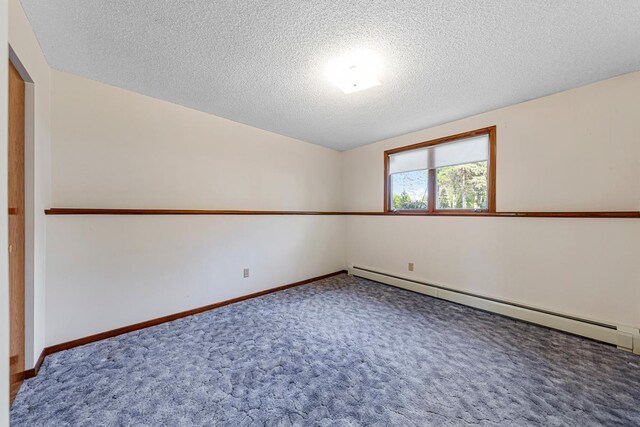 16 Crestview Bay, Faribault, MN 55021 - empty room featuring a baseboard heating unit, carpet flooring, a textured ceiling, and baseboards