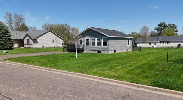 305 4th Ave SW, Milltown, WI 54858 - view of front of home with a front lawn and a wooden deck