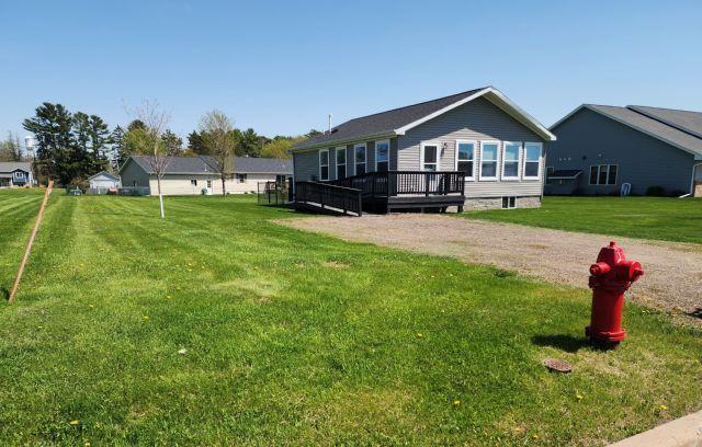 305 4th Ave SW, Milltown, WI 54858 - back of property featuring a wooden deck, a yard, and driveway