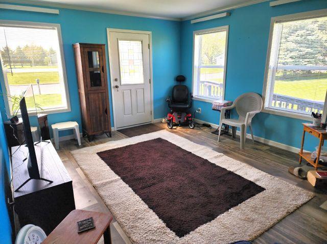 305 4th Ave SW, Milltown, WI 54858 - foyer entrance featuring wood finished floors, crown molding, healthy amount of natural light, and baseboards