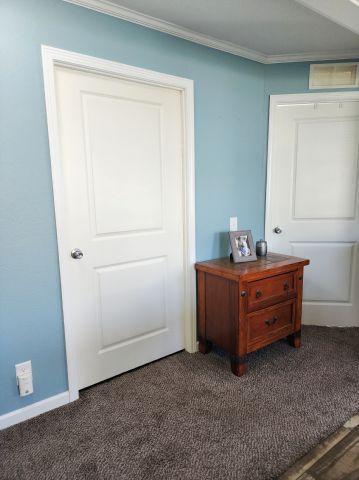 305 4th Ave SW, Milltown, WI 54858 - bedroom with crown molding, carpet flooring, and baseboards