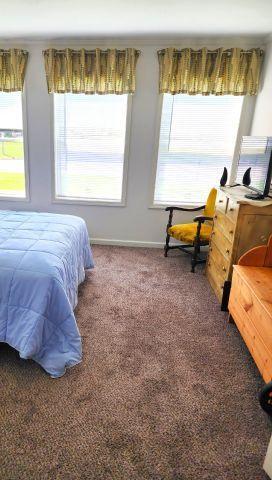 305 4th Ave SW, Milltown, WI 54858 - carpeted bedroom with multiple windows and baseboards