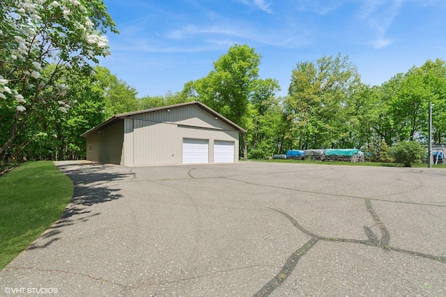 28075 Zuni St NW, Isanti, MN 55040 - detached garage with view of wooded area