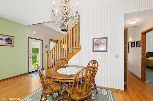 28075 Zuni St NW, Isanti, MN 55040 - dining room featuring light wood finished floors, a chandelier, and baseboards