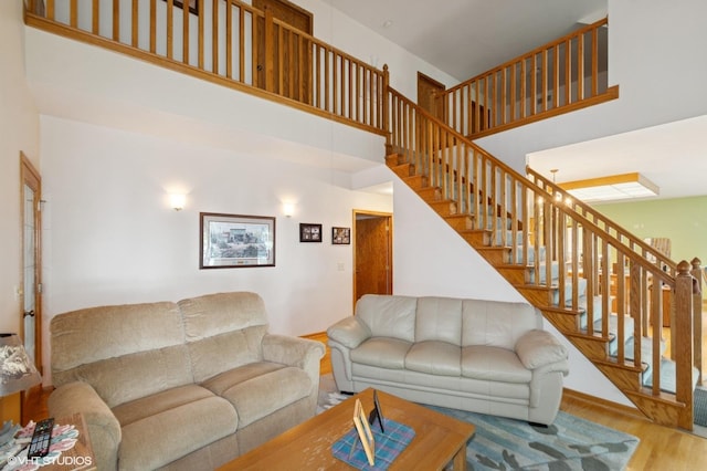 28075 Zuni St NW, Isanti, MN 55040 - living room with wood finished floors, a high ceiling, and stairs