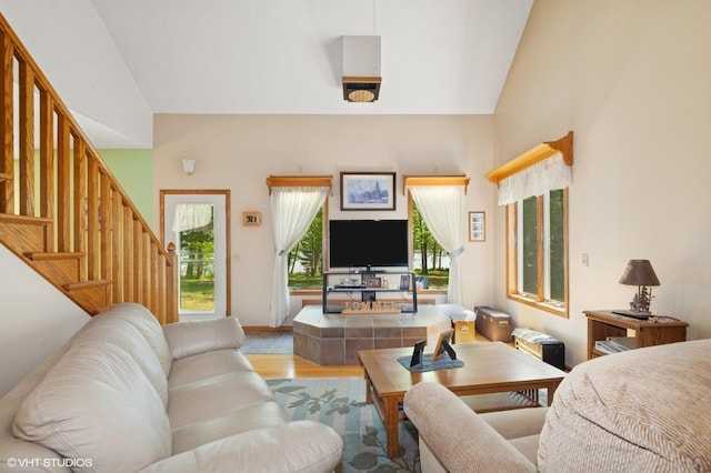 28075 Zuni St NW, Isanti, MN 55040 - living room with healthy amount of natural light, light wood finished floors, stairs, baseboards, and high vaulted ceiling