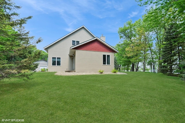 28075 Zuni St NW, Isanti, MN 55040 - rear view of house with a lawn, a chimney, and an outbuilding