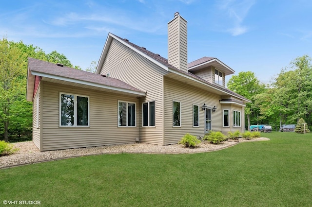 28075 Zuni St NW, Isanti, MN 55040 - rear view of property featuring a chimney and a lawn