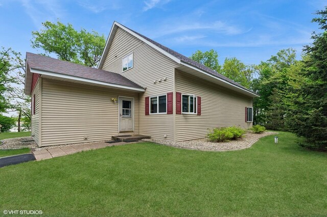 28075 Zuni St NW, Isanti, MN 55040 - rear view of house with a lawn and roof with shingles