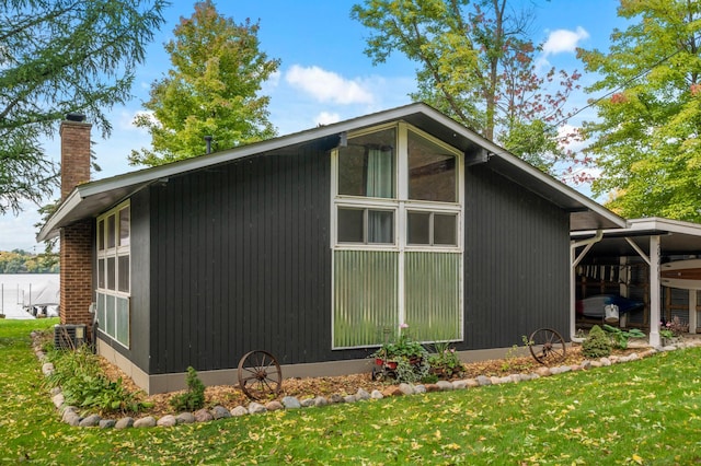 29408 Francis Lake Dr NW, Bradford Twp, MN 55040 - view of home's exterior featuring a chimney, a yard, and central AC