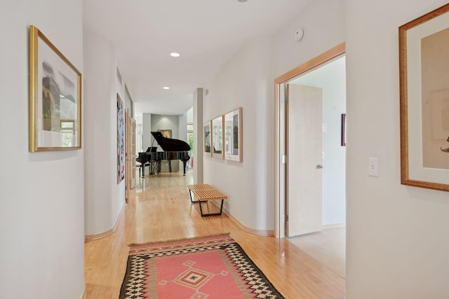 hall featuring light wood finished floors and recessed lighting