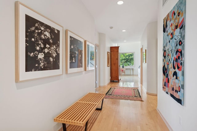hallway featuring wood finished floors, recessed lighting, and baseboards