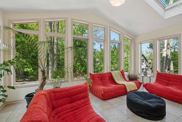 sunroom with a skylight, vaulted ceiling, tile patterned flooring, and baseboards