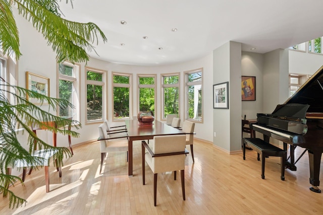 dining space with light wood-type flooring, baseboards, and recessed lighting
