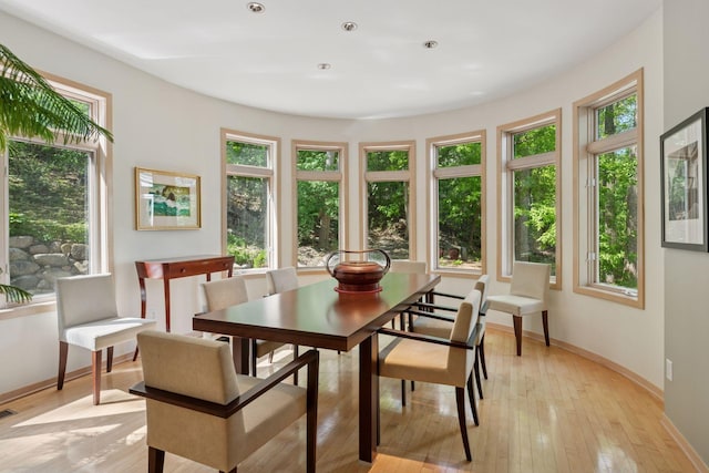 dining area with baseboards, light wood-style flooring, and recessed lighting