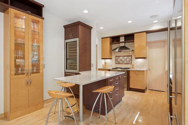 kitchen with stainless steel stove, light wood finished floors, open shelves, backsplash, and a kitchen breakfast bar