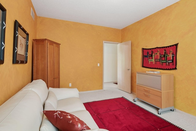 living area featuring light carpet and baseboards