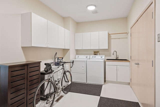 laundry area with washing machine and dryer and a sink
