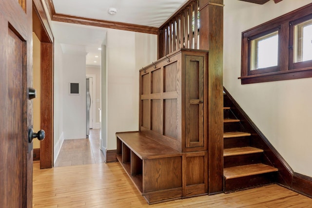 mudroom with crown molding, light wood-type flooring, and baseboards