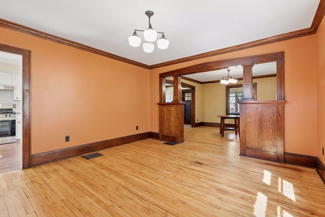 unfurnished dining area featuring a chandelier, light wood finished floors, baseboards, and crown molding