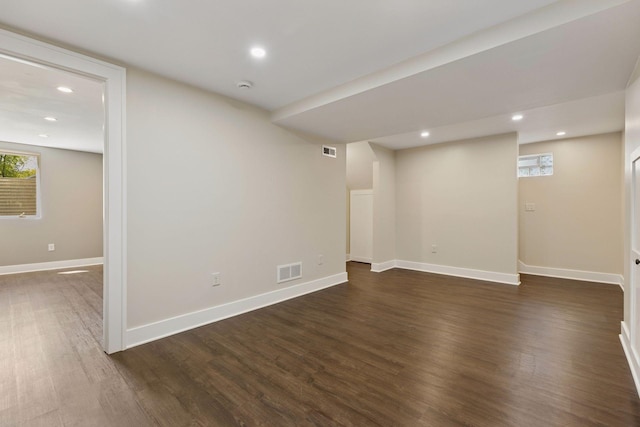 basement featuring dark wood-type flooring, recessed lighting, and baseboards