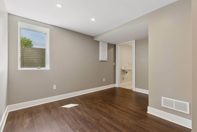 below grade area featuring wood finished floors, baseboards, and recessed lighting