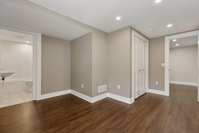 basement featuring wood finished floors, recessed lighting, and baseboards