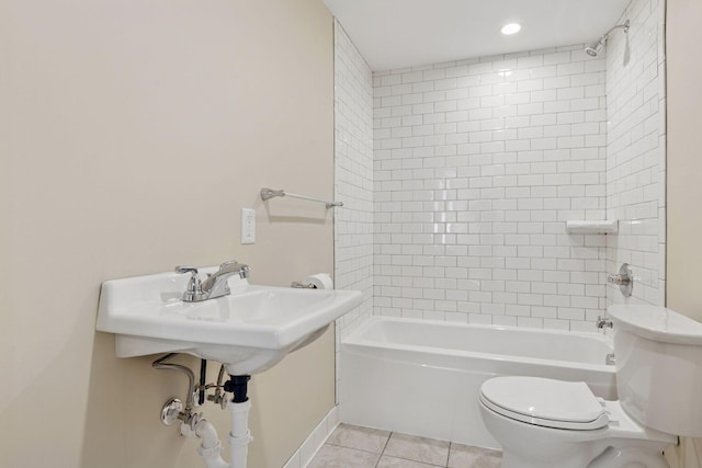 bathroom featuring toilet, tile patterned floors, and bathing tub / shower combination