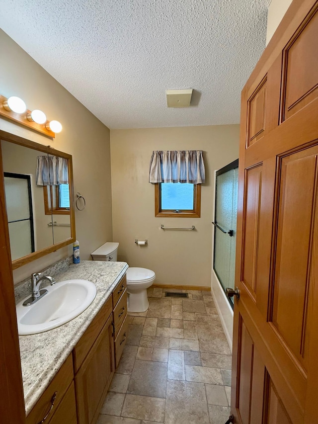 2705 6th St SW, Willmar, MN 56201 - bathroom with vanity, a textured ceiling, enclosed tub / shower combo, and stone finish flooring