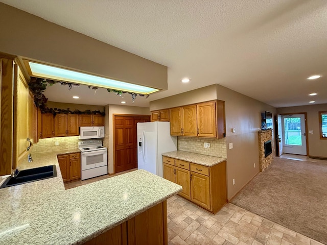2705 6th St SW, Willmar, MN 56201 - kitchen with white appliances, a fireplace, decorative backsplash, recessed lighting, and brown cabinetry