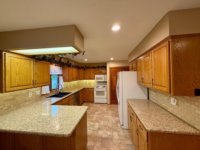 2705 6th St SW, Willmar, MN 56201 - kitchen featuring white appliances, brown cabinetry, a peninsula, recessed lighting, and tasteful backsplash