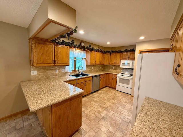 2705 6th St SW, Willmar, MN 56201 - kitchen with white appliances, a peninsula, tasteful backsplash, stone tile flooring, and recessed lighting
