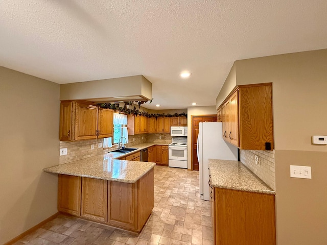 2705 6th St SW, Willmar, MN 56201 - kitchen featuring white appliances, a peninsula, brown cabinets, tasteful backsplash, and recessed lighting