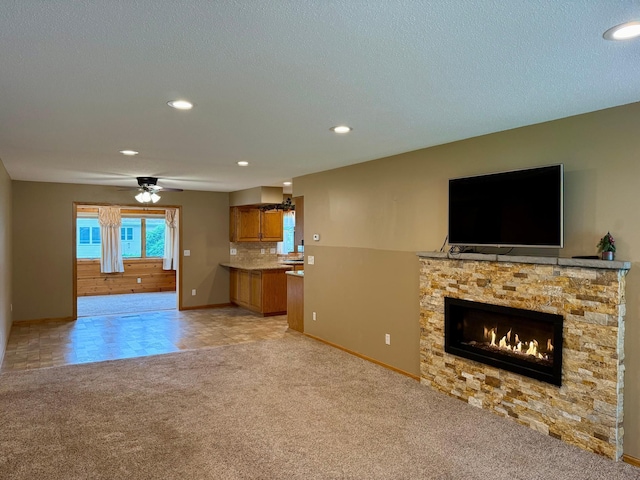 2705 6th St SW, Willmar, MN 56201 - unfurnished living room featuring light carpet, a fireplace, recessed lighting, and a ceiling fan