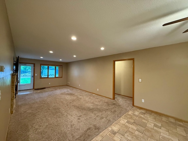 2705 6th St SW, Willmar, MN 56201 - unfurnished room with ceiling fan, recessed lighting, light carpet, stone tile floors, and a textured ceiling